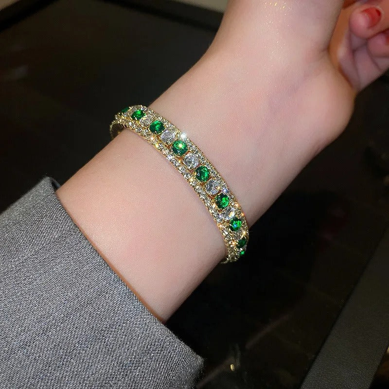 Elegant gold bracelet with green and clear crystals, perfect for fashion accessories and gifts.