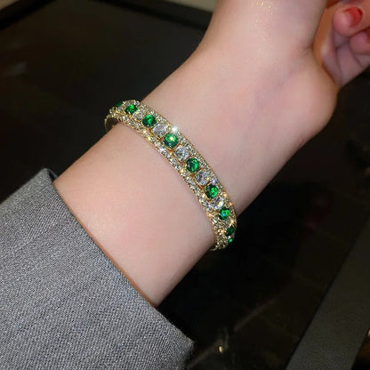 Elegant gold bracelet with green and clear crystals, perfect for fashion accessories and gifts.