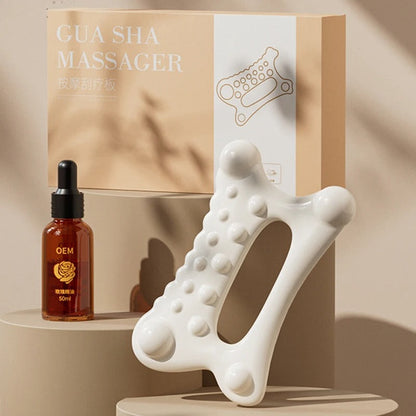 White Gua Sha massager tool with massage oil, ideal for facial and body relaxation
