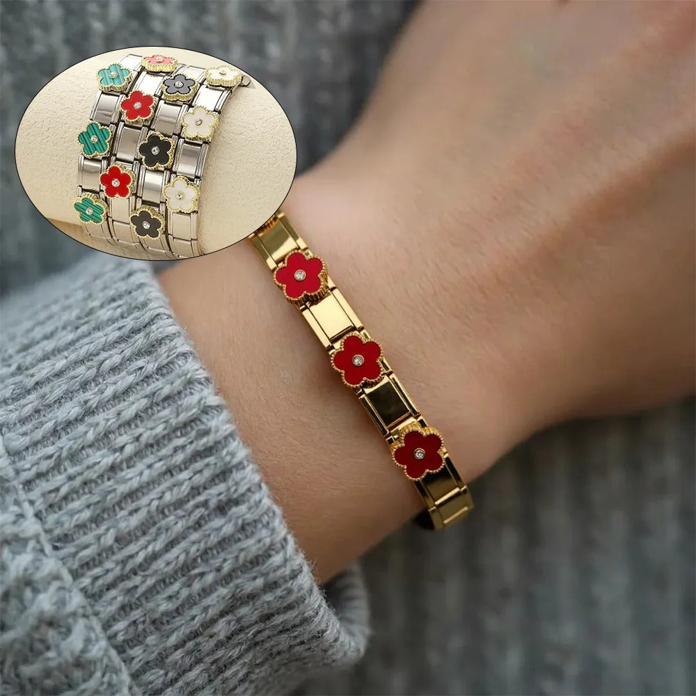 Gold flower bracelet with red enamel blooms, worn on wrist, inset shows multi-color floral designs
