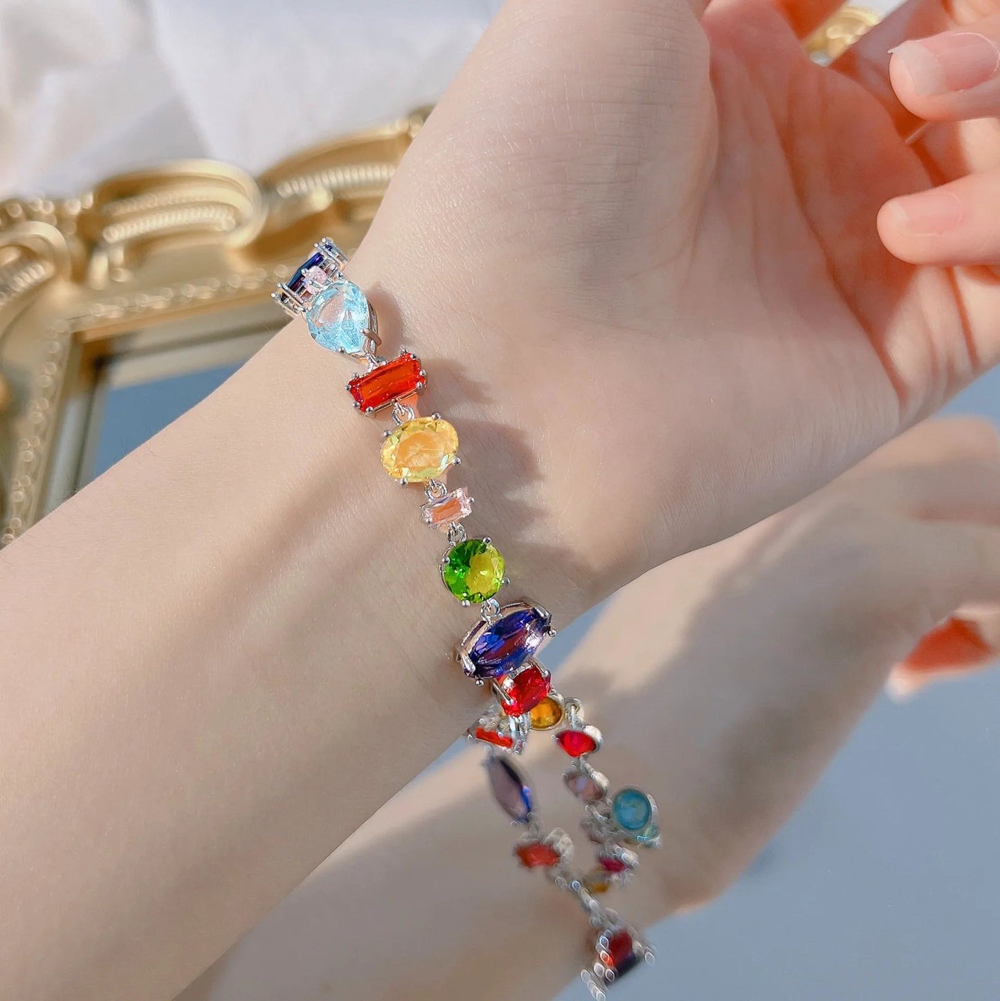 Colorful gemstone bracelet with rainbow crystals on wrist, elegant fashion accessory for women