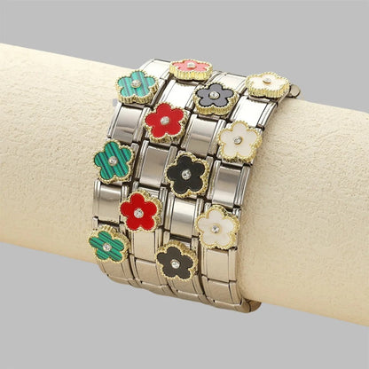 Colorful flower charm bracelet with enamel petals and crystal centers on silver-toned links