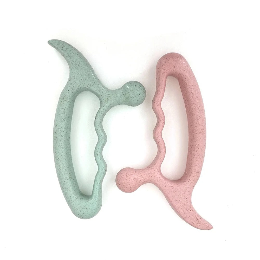 Pastel green and pink ergonomic massage tools for relaxation and muscle relief