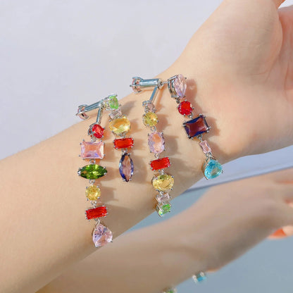 Colorful gemstone drop earrings with silver hooks, featuring vibrant rainbow crystals in multiple shapes.