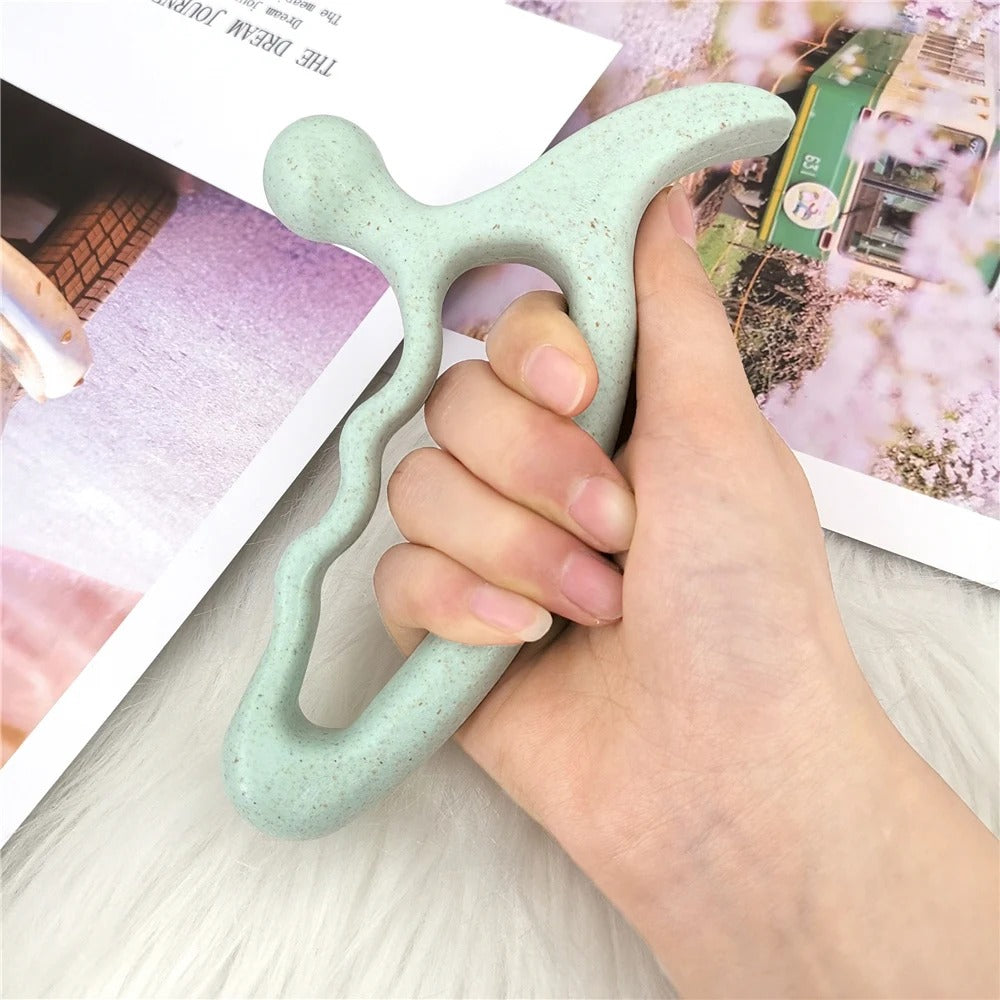 Hand holding mint green ergonomic massage tool for muscle relief and relaxation