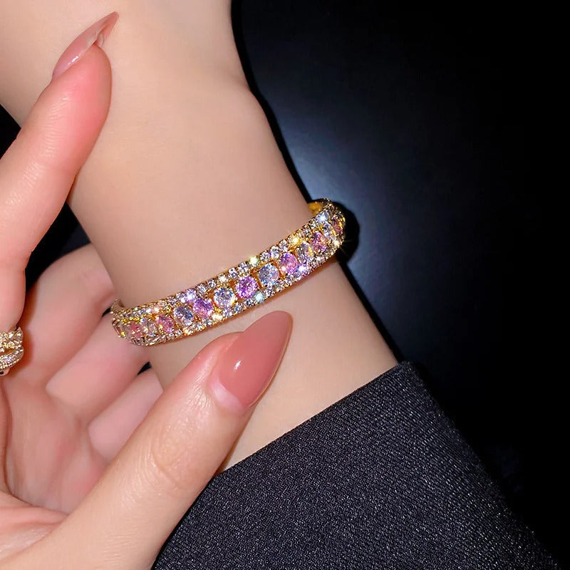 Elegant gold bracelet with sparkling pink and clear crystals, perfect for fashion accessories.