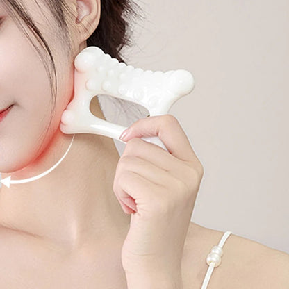 White facial massage tool for neck and jawline contouring, promoting relaxation and skin care routine