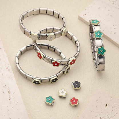 Stainless steel flower charm bracelets with interchangeable red, white, black, and green enamel charms for women's fashion jewelry.