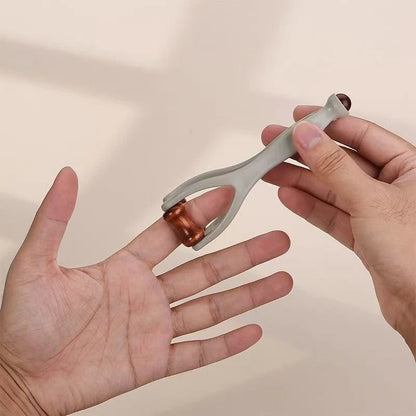 Hand holding dual roller massager for palm and finger relief, portable self-massage tool