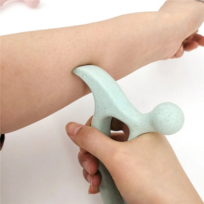 Hand using light green massage tool on arm for muscle relief