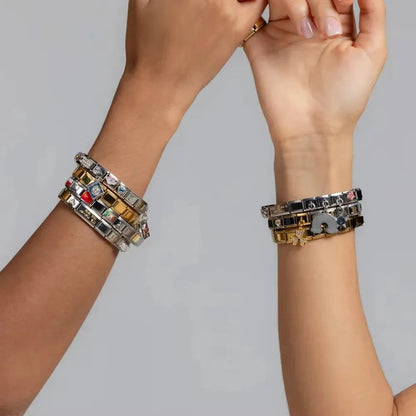 Stylish charm bracelets with colorful enamel and crystal details, perfect for fashion lovers in UAE.