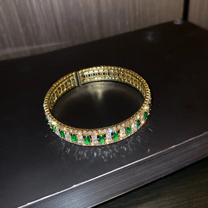 Gold bangle with emerald and diamond accents, elegant fashion jewelry for women