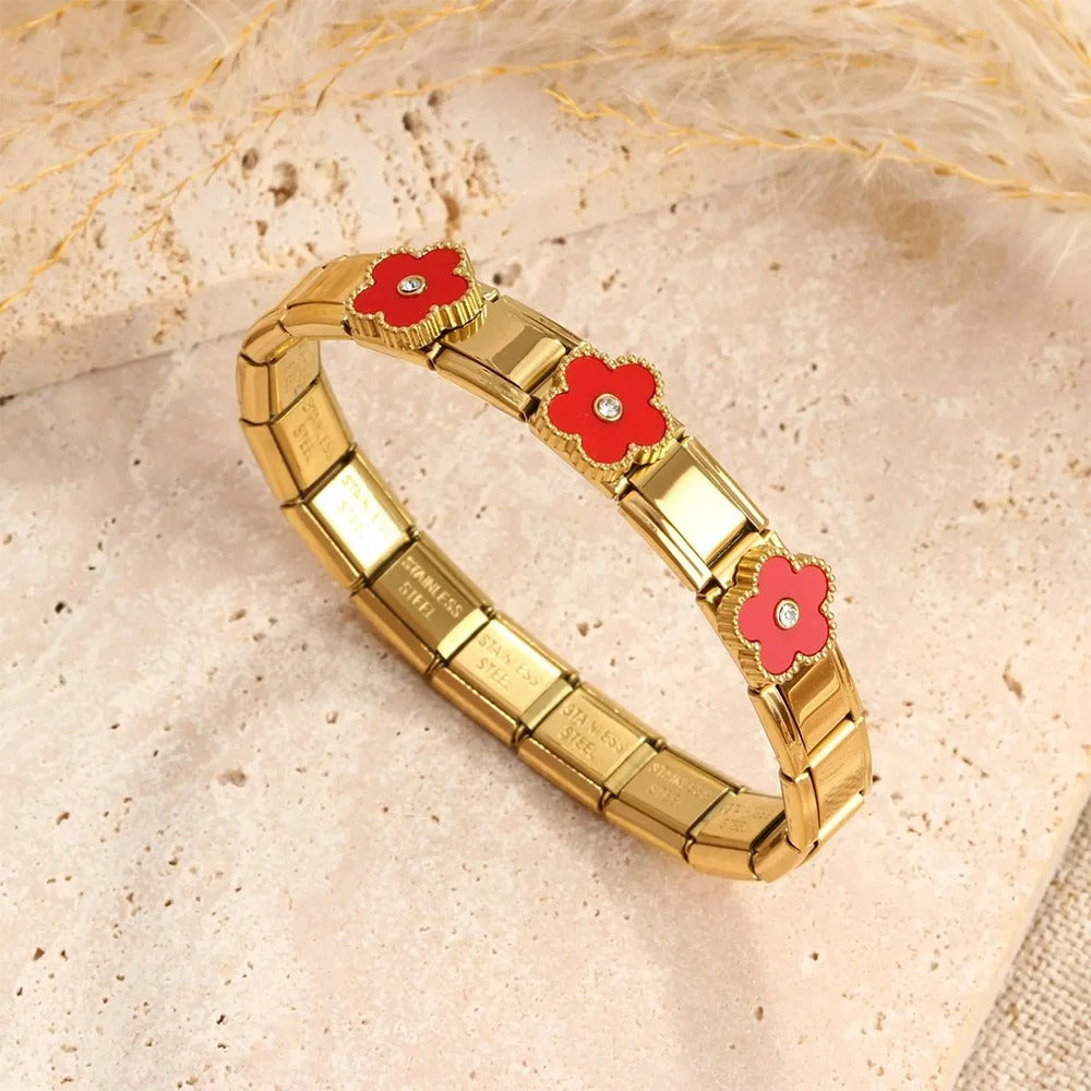 Gold stainless steel bracelet with red flower charms and crystal centers, elegant fashion accessory